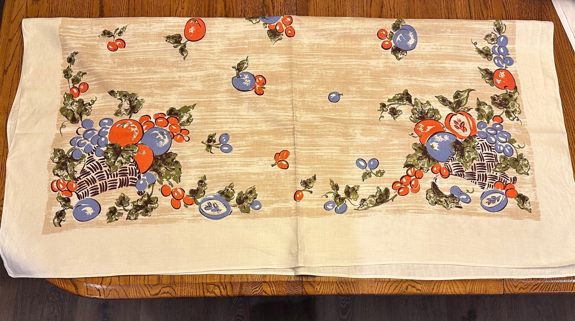 Decorative tablecloth with fruit pattern on a wooden surface