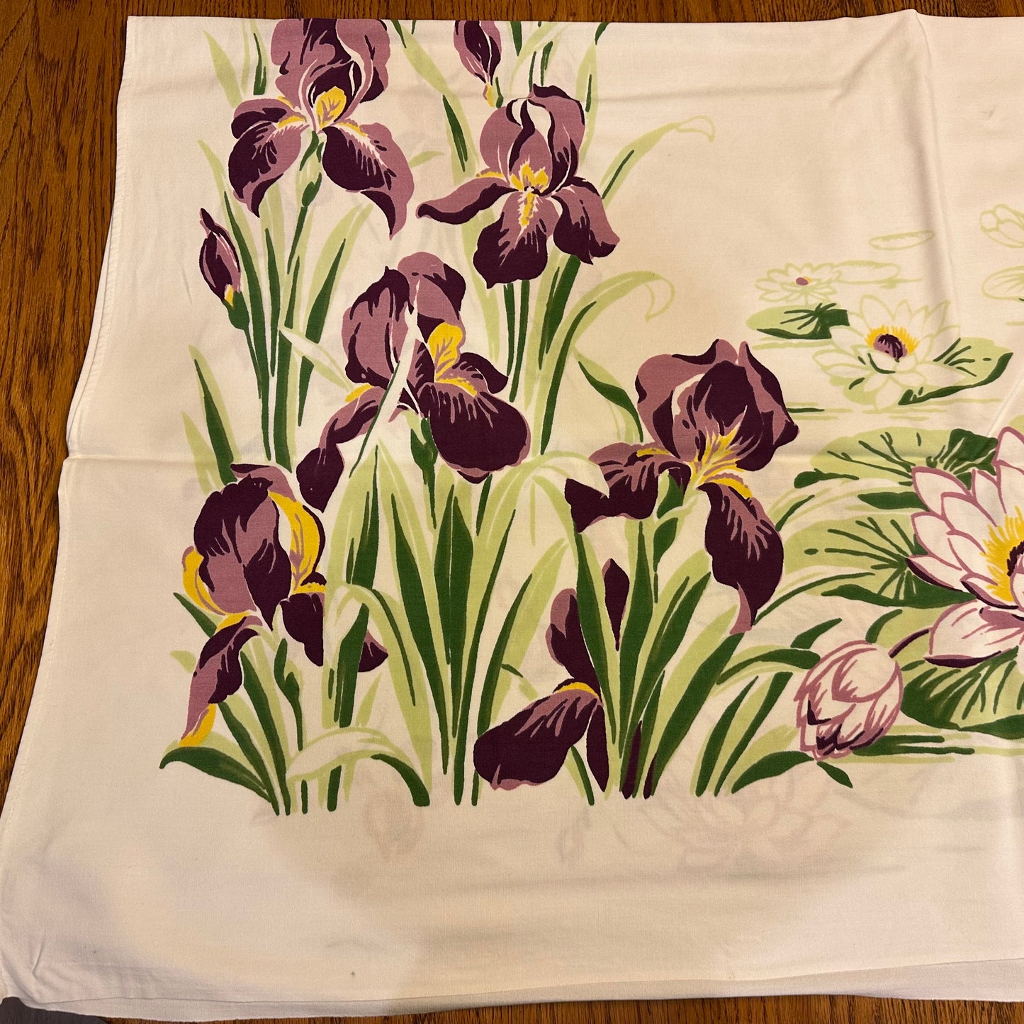Floral patterned fabric with purple flowers on a wooden surface