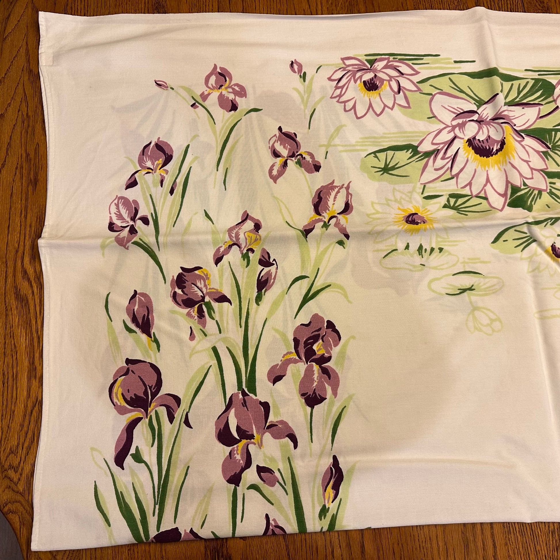 Floral-patterned fabric with purple flowers on a wooden surface